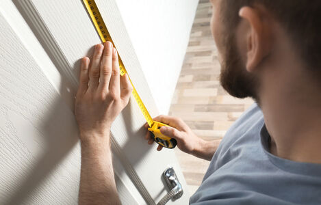 Man,Measuring,Door,In,Room,,Closeup.,Construction,Tool