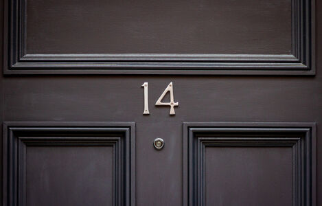 House,Number,14,With,Peephole,On,A,Dark,Wooden,Front